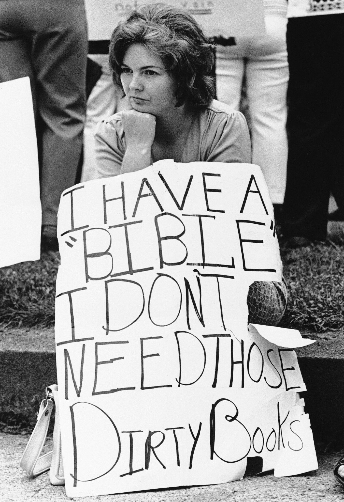 A crusader against textbooks sat curbside during a protest in Charleston, West Virginia, in 1974. (AP Photo)