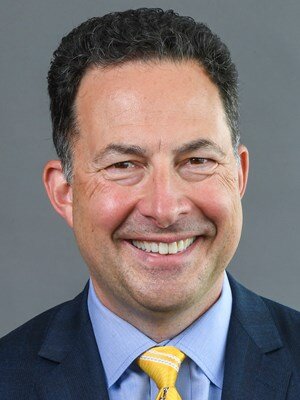 Tony Caridi’s passion for calling WVU football and basketball action is clear every time he steps behind a microphone. (Courtesy WVU Athletics)